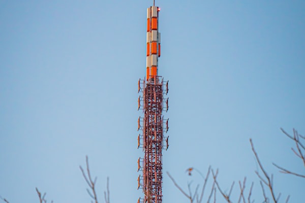 Telecommunications cell tower against blue sky representing 5G connectivity