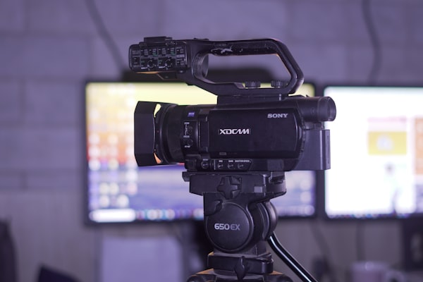 Professional video camera on tripod in studio for content production
