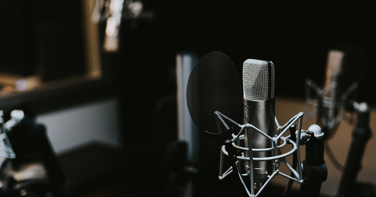 Podcaster editing audio on a laptop