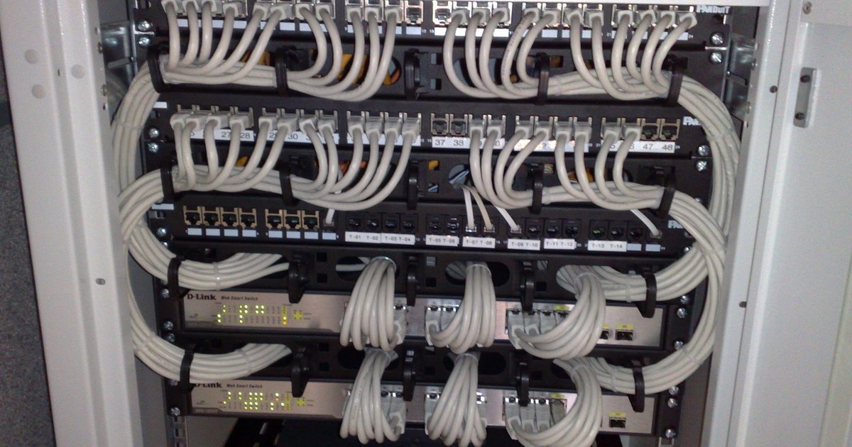Rack-mounted network switches and patch panels inside a data centre cabinet
