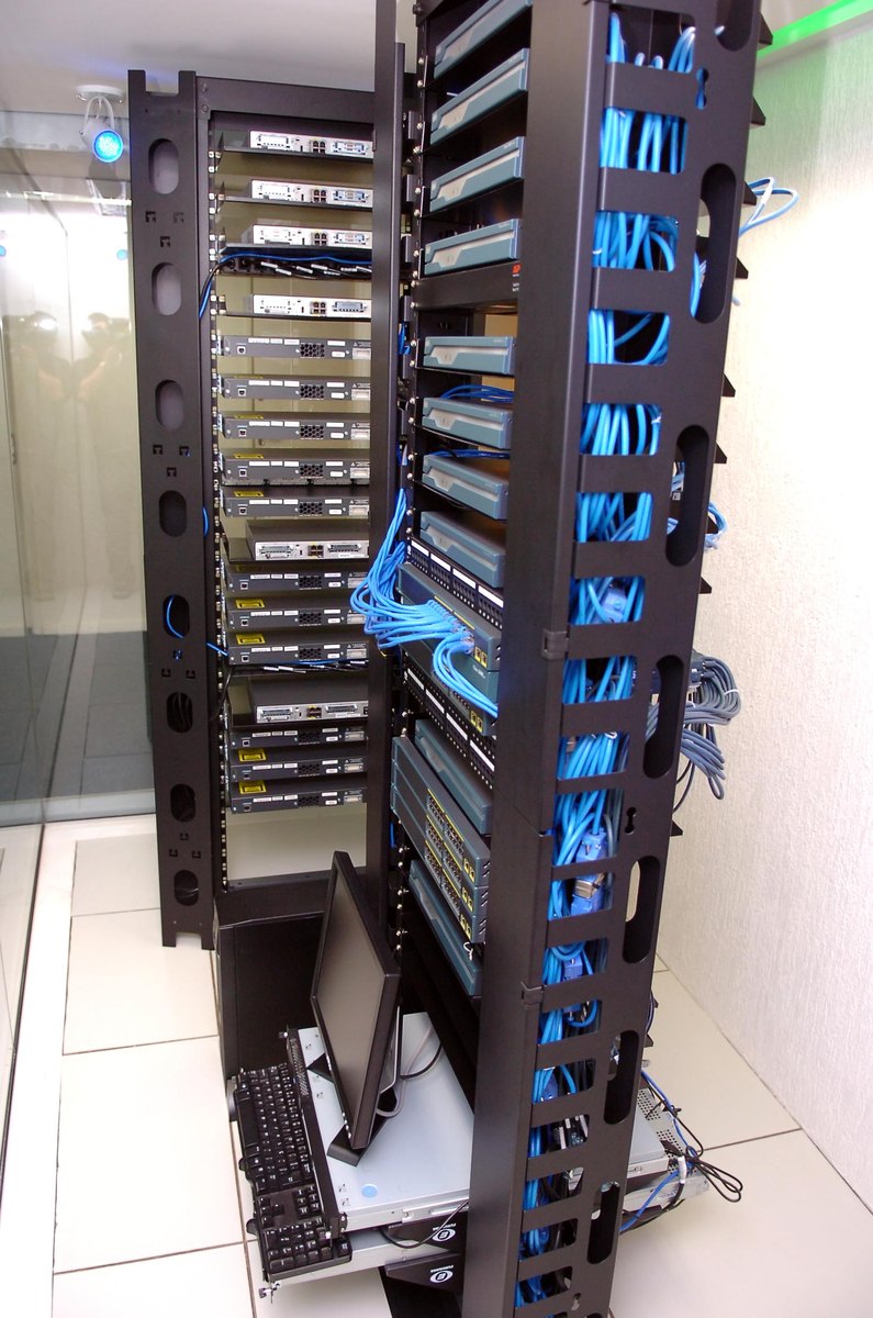 Rows of server and networking equipment in a data centre hall