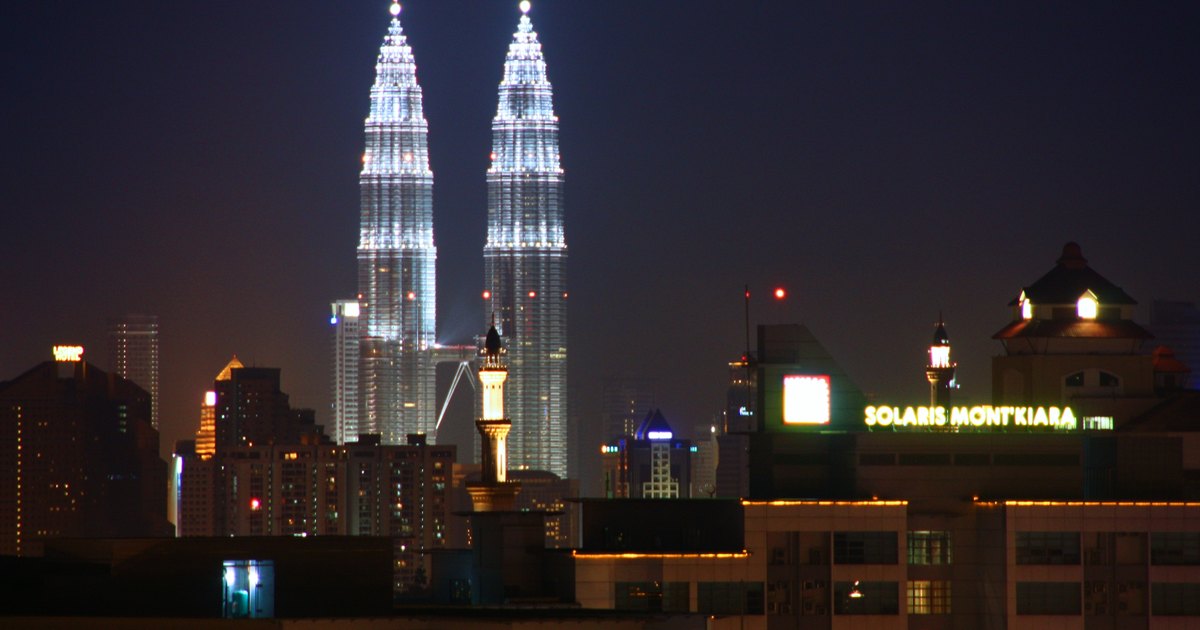 Kuala Lumpur skyline at night, with the Petronas Towers and Mont Kiara high-rises lit up
